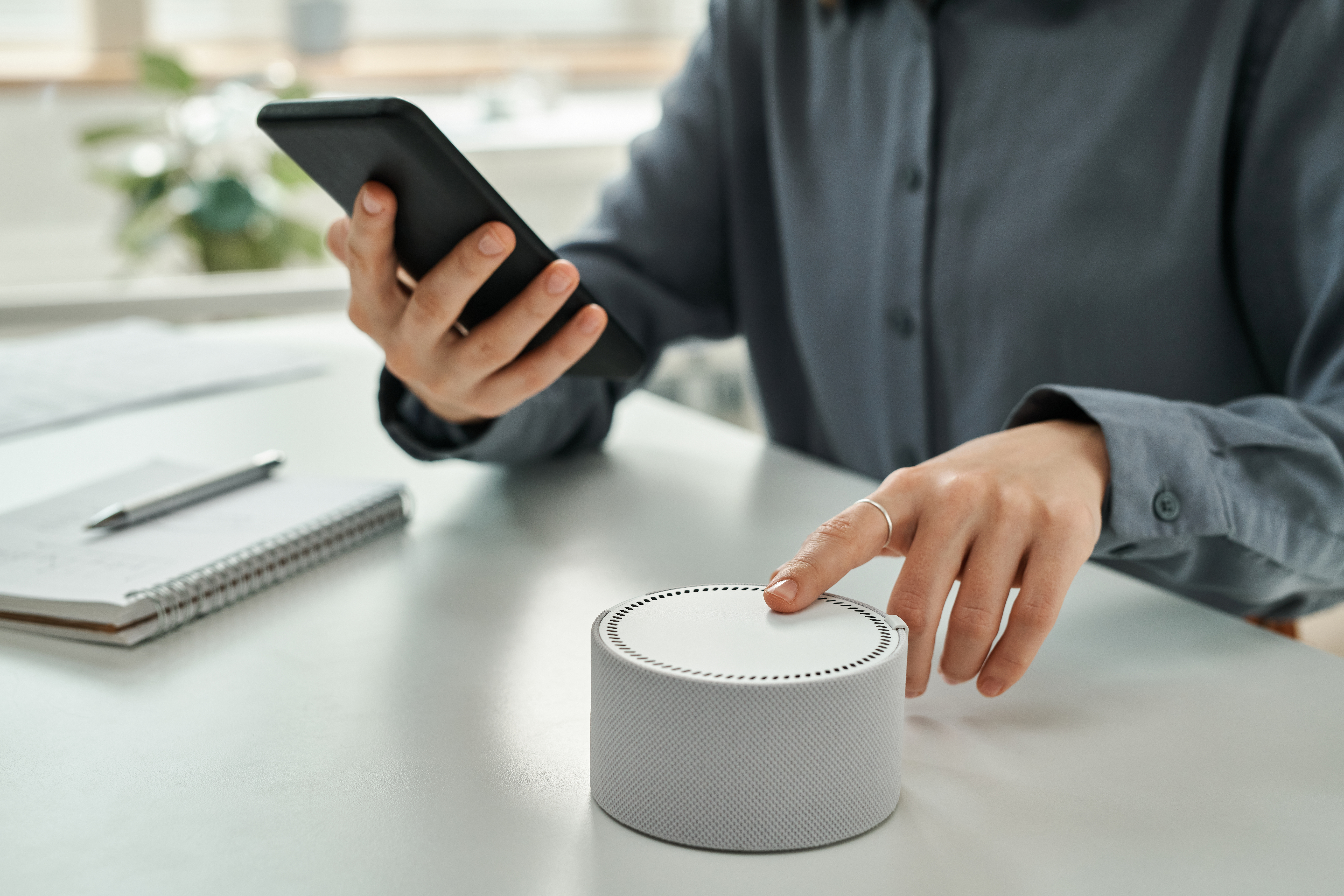 Businesswoman using smart speaker at office businesswoman using smart speaker at office 2025 03 18 22 20 49 utc