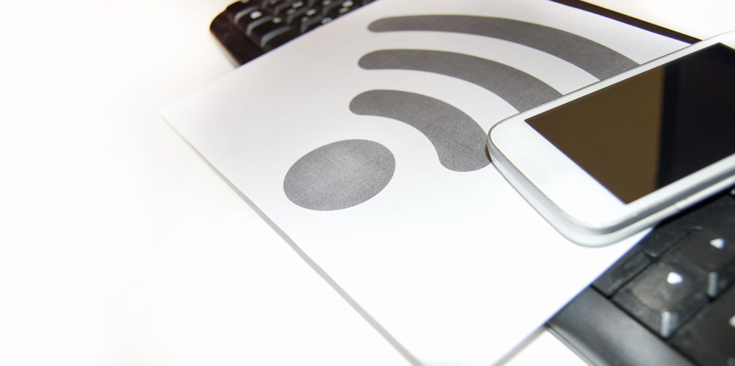 Wi-Fi symbol on a piece of paper near the computer keyboard and mobile phone, wireless Internet, copy space connection 2024 12 07 13 58 08 utc scaled